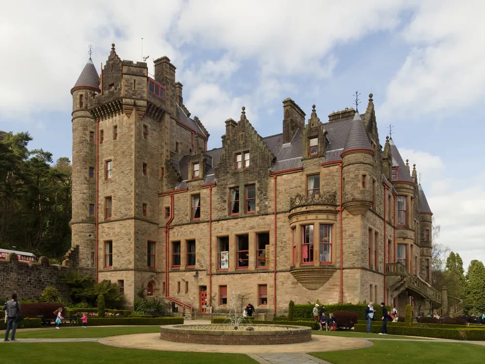 Belfast Castle on the slopes of Cave Hill — the Scottish Baronial Victorian castle with Belfast city and Belfast Lough visible below