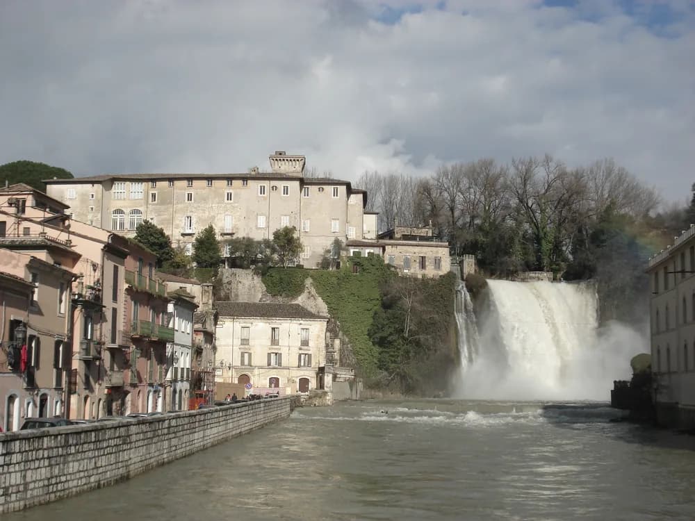 Boncompagni Castle above the Cascata Grande in Isola del Liri — the 15th-century castle on the travertine rock island where the Liri River splits into a 27-metre urban waterfall