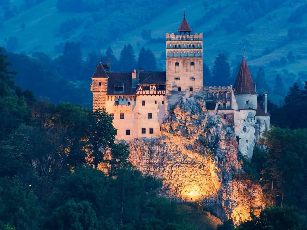 Bran Castle perched on its limestone rock in the Bran Pass, Transylvania, at dusk