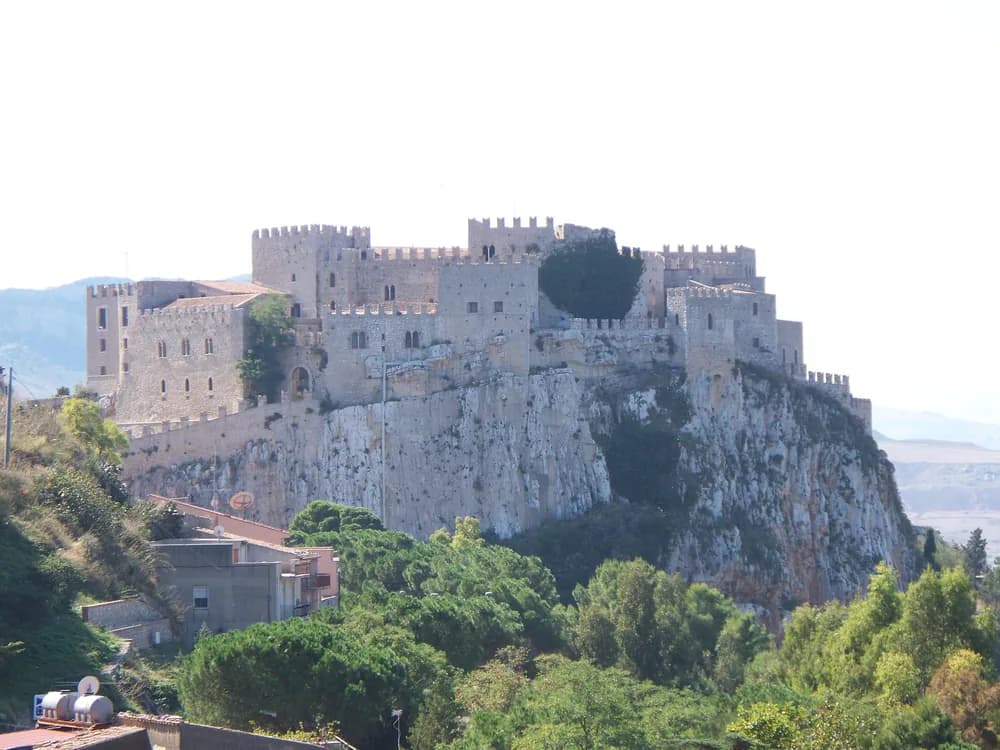 Castle of Caccamo rising above the Sicanian Mountains on its limestone spur, the Norman fortress of the Chiaramonte lords with the Sicilian hillside town below