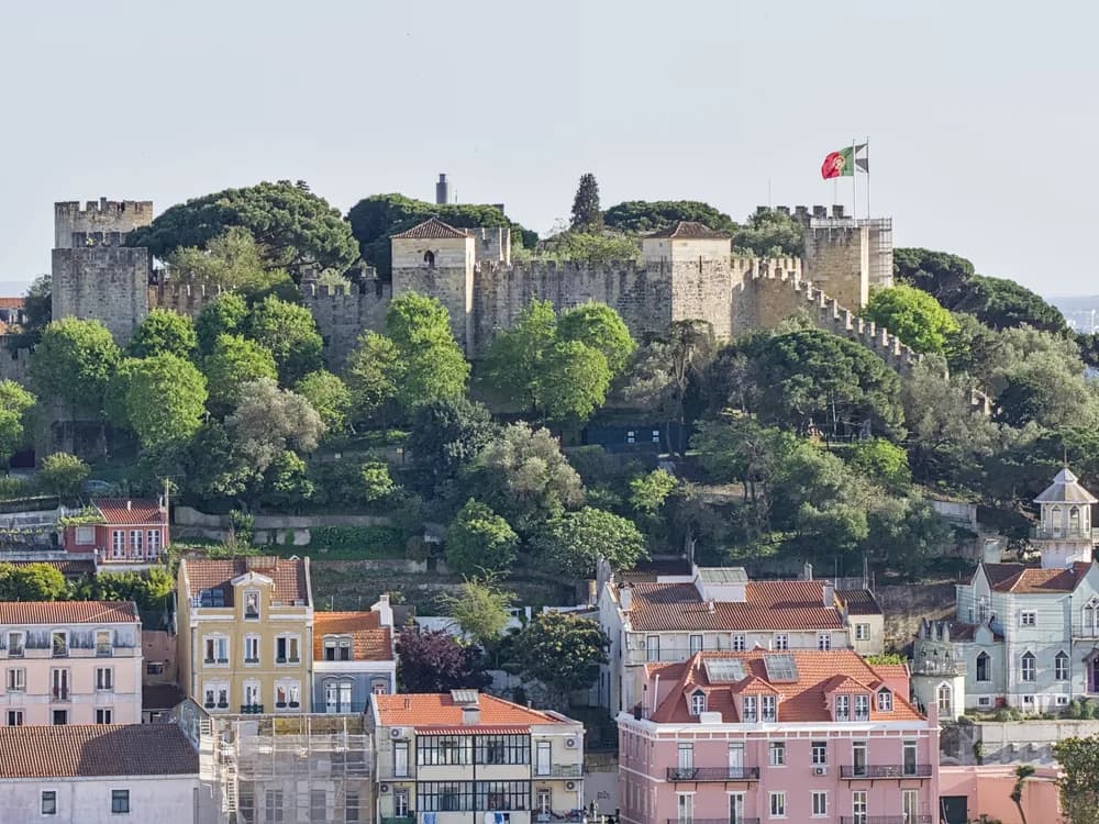 The medieval ramparts of Castelo de São Jorge overlooking the rooftops of Lisbon and the Tagus estuary