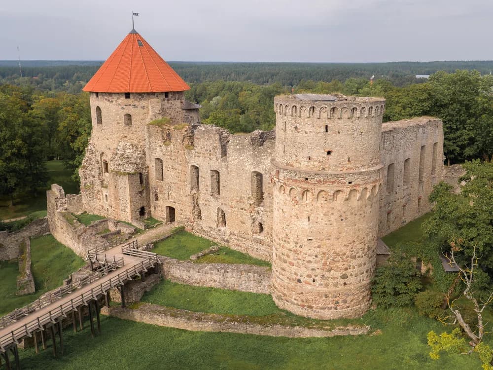 Cēsis Castle ruins and towers rising above the Latvian town in autumn