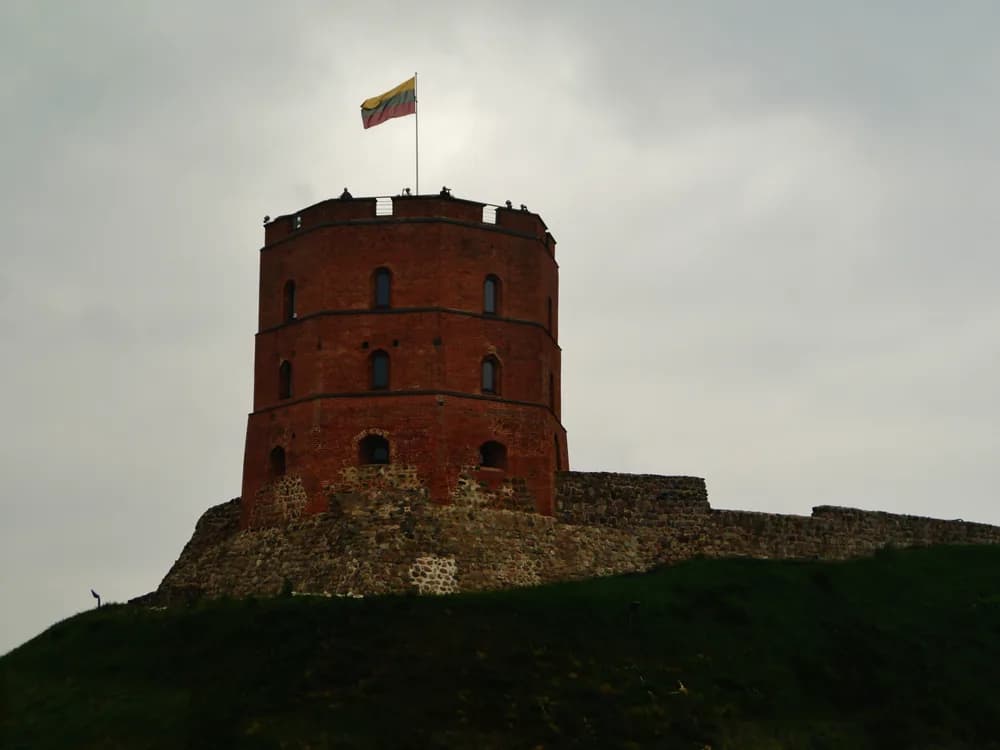 Gediminas Tower above the Vilnius Old Town skyline at sunset in Lithuania