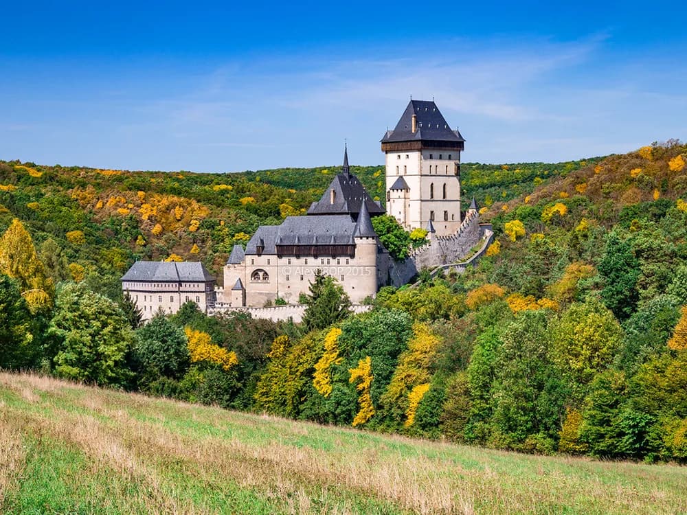 Karlštejn Castle rising in Gothic tiers above the forested Berounka valley, 30km from Prague