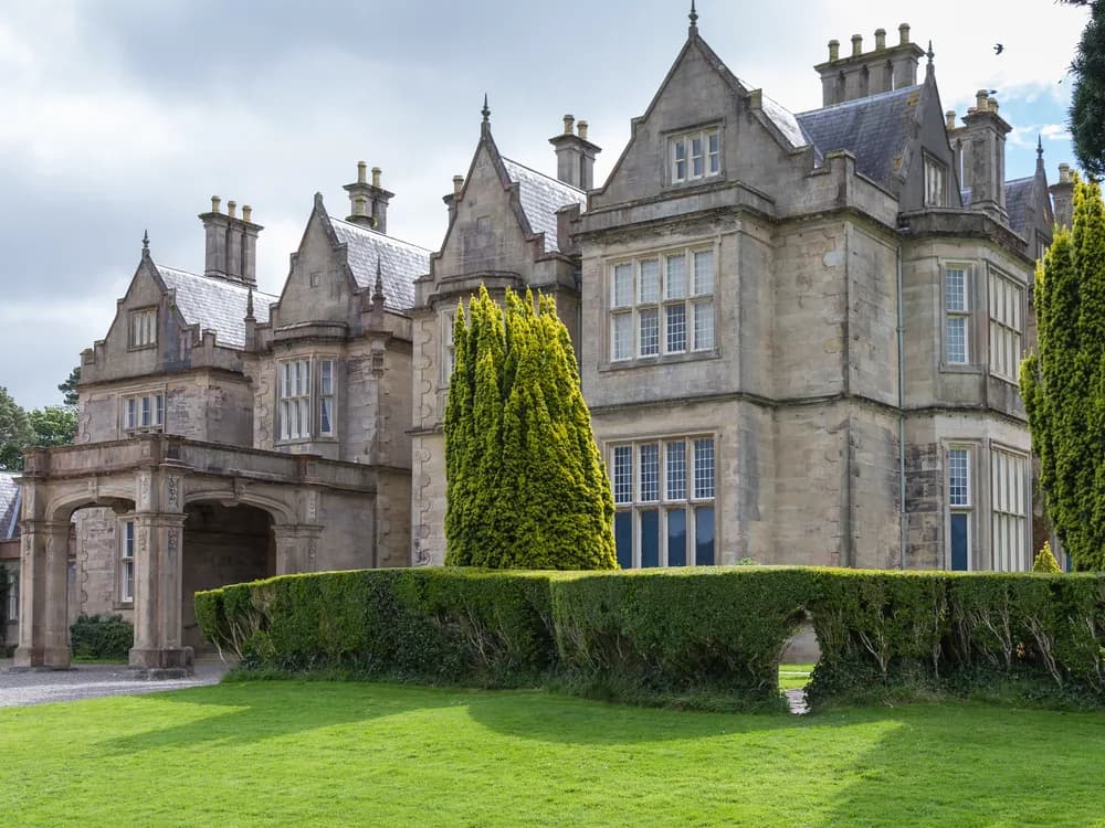 Muckross House in Killarney National Park — the 1843 Victorian Elizabethan Revival mansion that Queen Victoria visited in 1861, now owned by the Irish state with freely accessible gardens and grounds