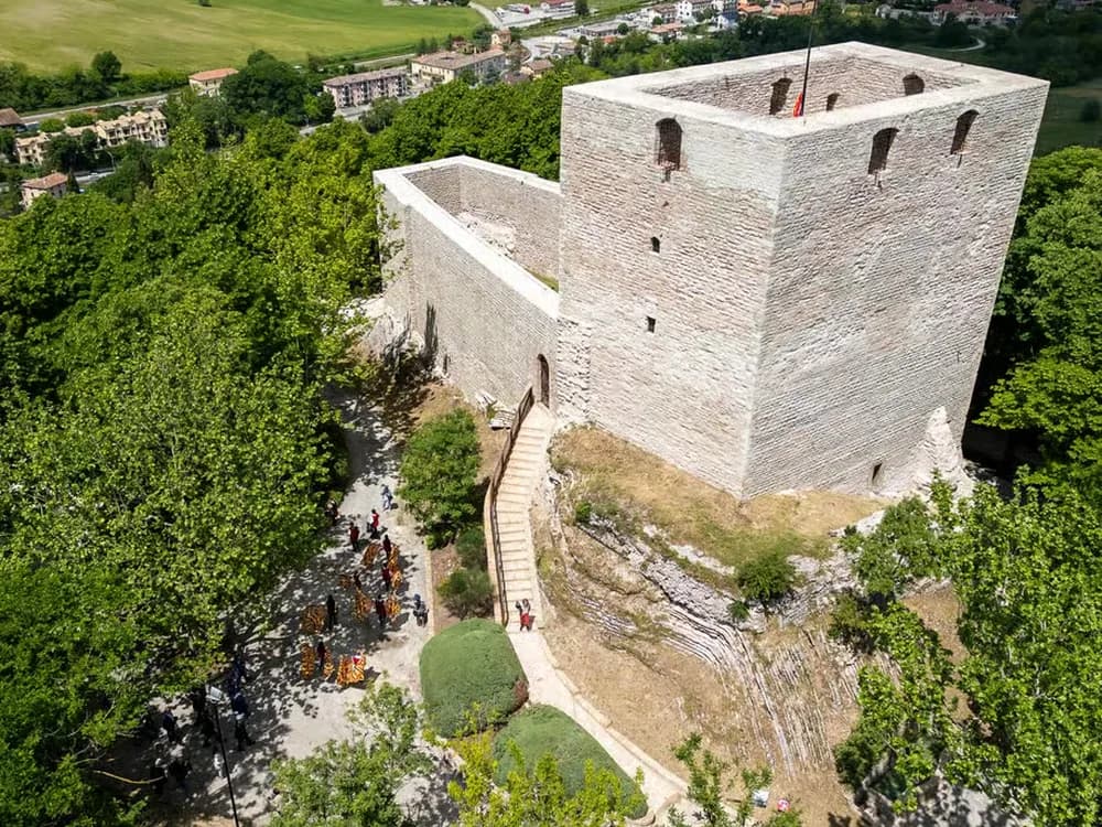 Rocca di Albornoz atop Sassoferrato in the Marche — the 14th-century papal fortress built by Cardinal Albornoz's network to reassert Avignon papal control over the Papal States, with panoramic views over the Marche Apennines