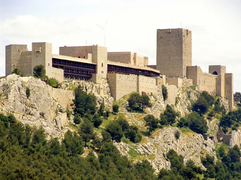 Castillo de Santa Catalina above Jaén, Andalusia — the reconquest castle's towers and walls on the cerro, with the olive oil landscape of the Province of Jaén extending to the horizon