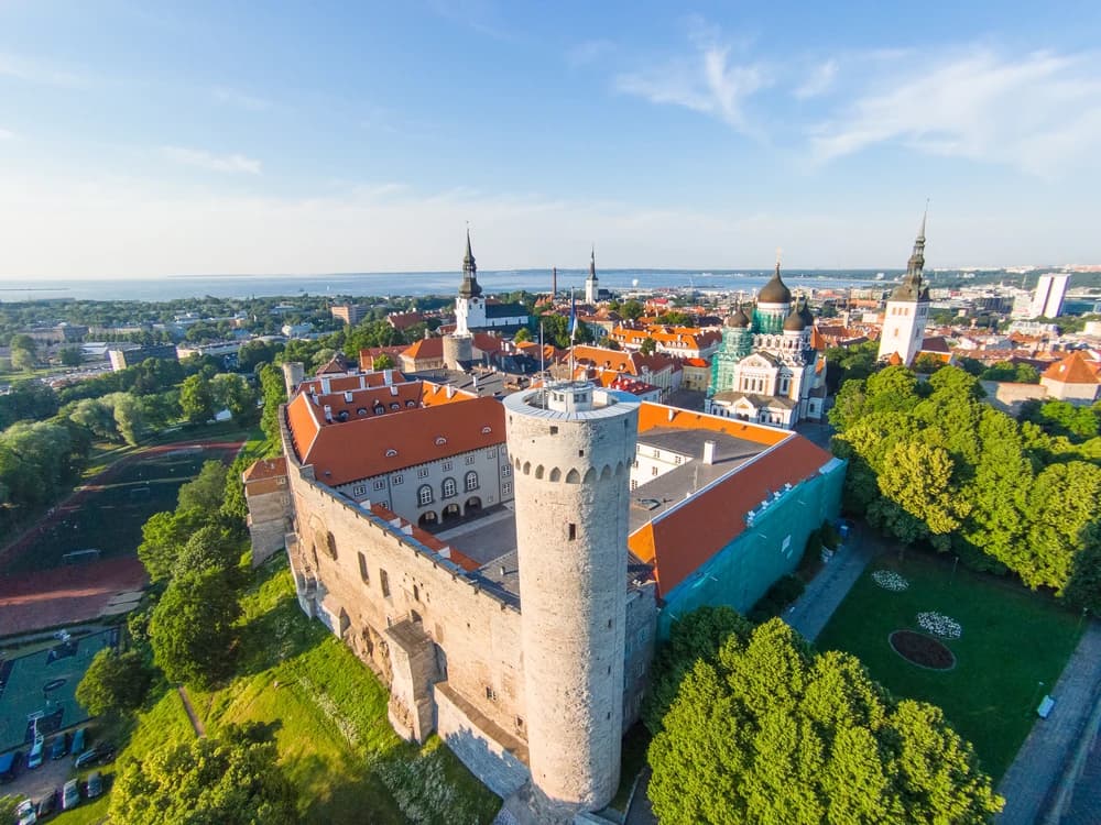 Toompea Castle and Tall Hermann tower rising above Tallinn's red-roofed medieval lower town, Estonia