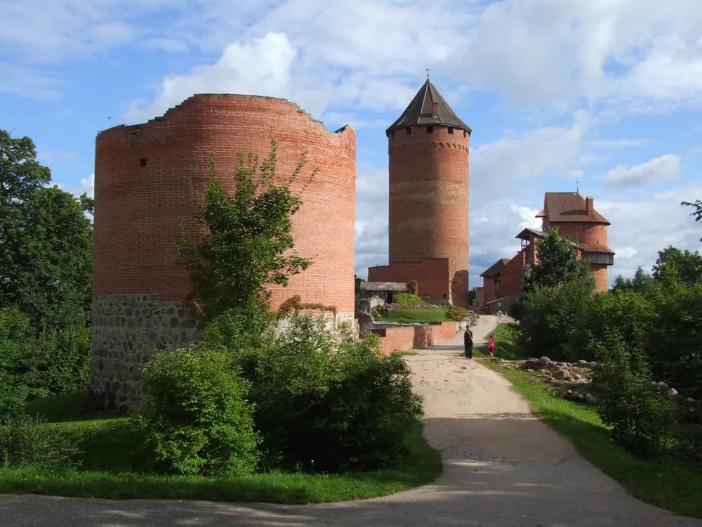 Turaida Castle red-brick towers rising above the Gauja valley forest in Latvia