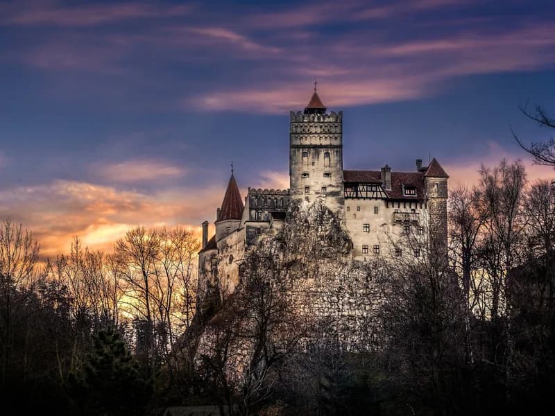 Bran Castle perched on its Transylvanian rock above the mountain pass — the anchor of the Transylvania Castle Route