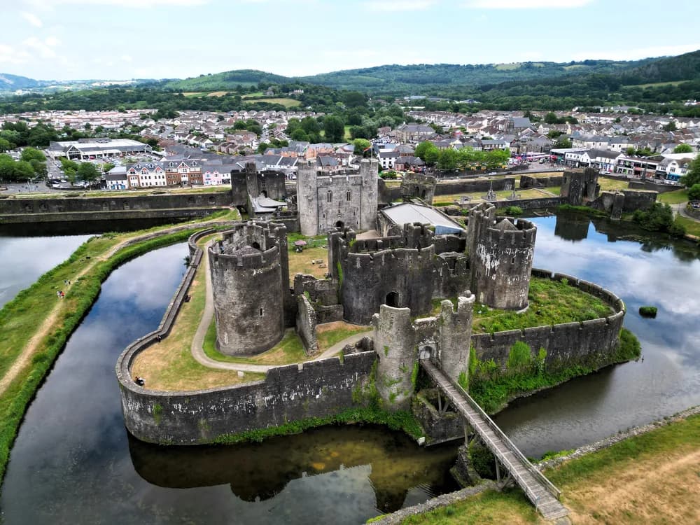 Caerphilly Castle and its vast water defences reflected in the moat lakes, South Wales