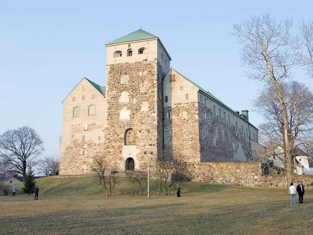 Turku Castle's grey granite towers at the mouth of the Aura River, Finland