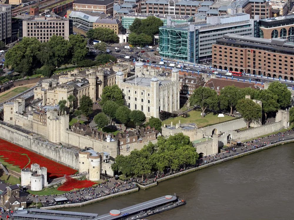 The Tower of London's medieval walls and White Tower reflected in the Thames