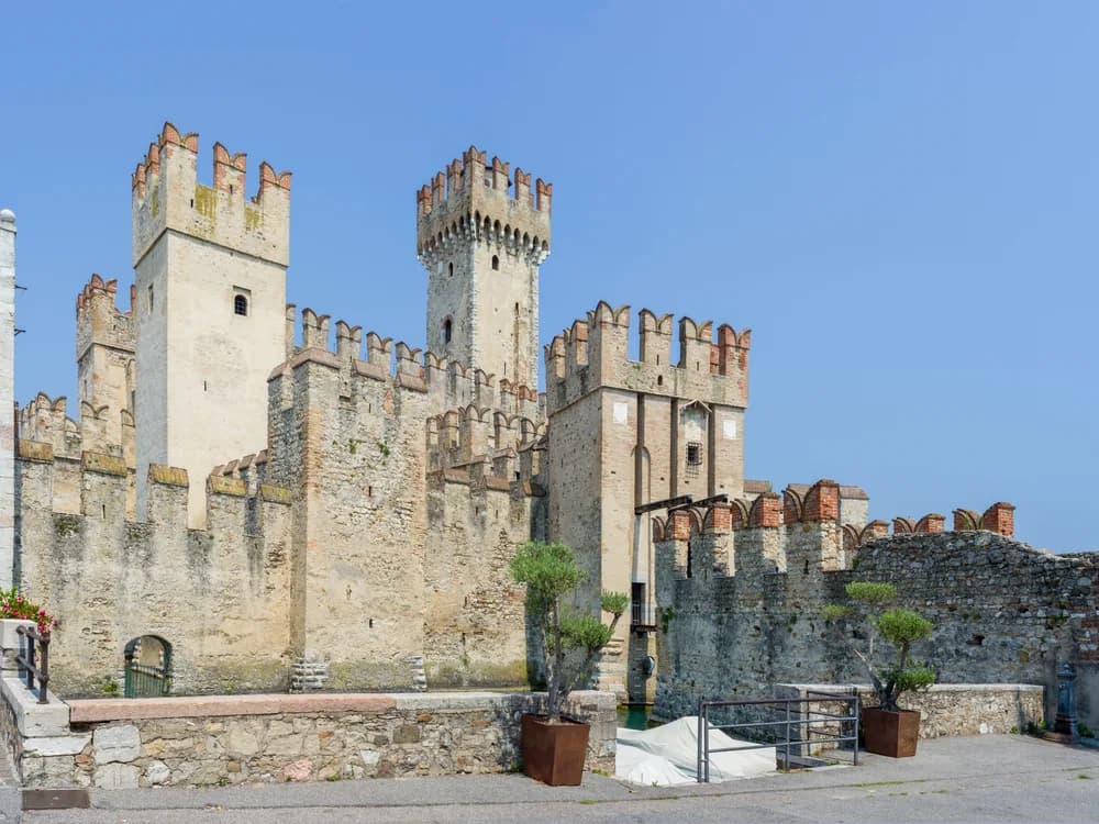 Scaligero Castle of Sirmione rising from the waters of Lake Garda at sunrise