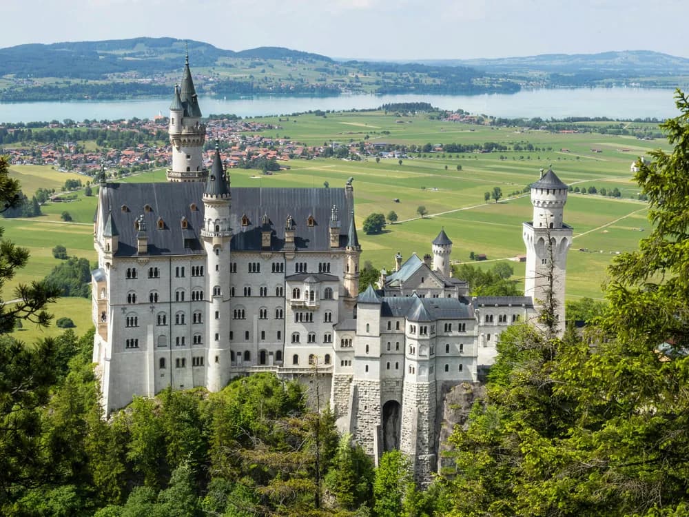 Neuschwanstein Castle rising above autumn forest in Bavaria