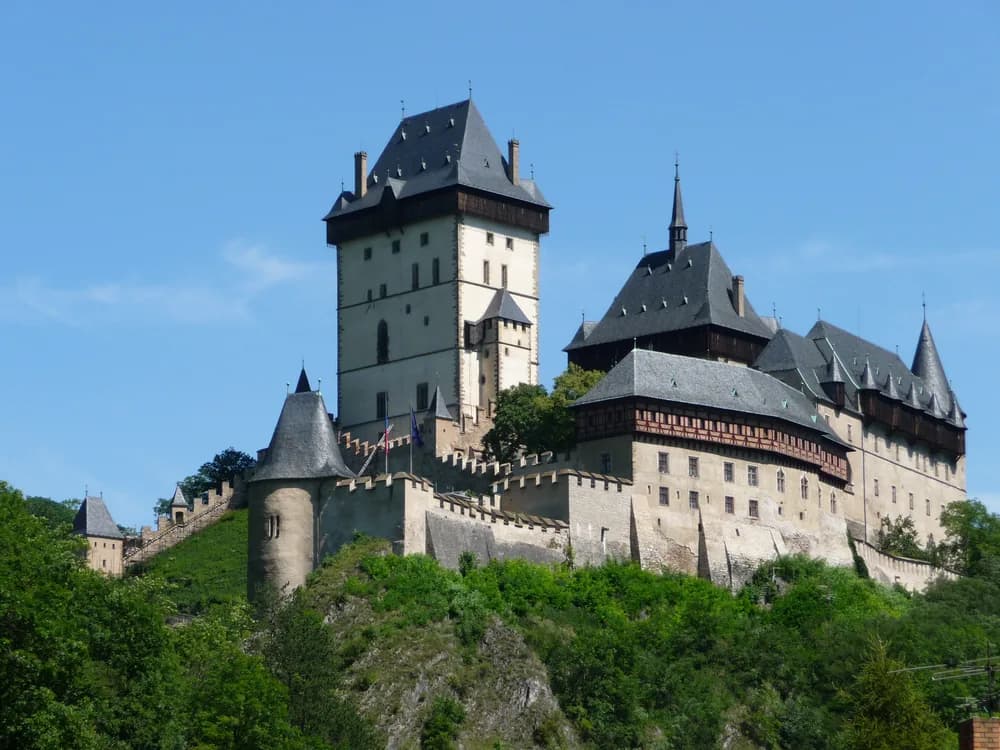 Karlštejn Castle perched on its forested ridge above the Berounka valley