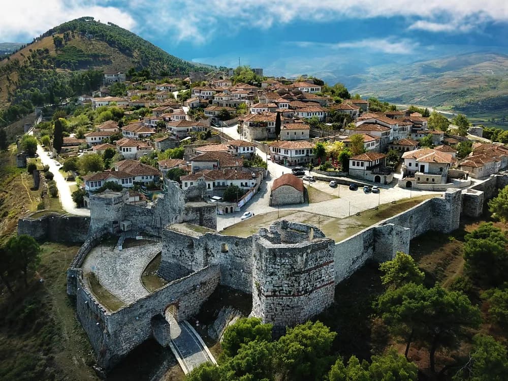 Berat Castle above the Ottoman-era City of a Thousand Windows, reflected in the Osum River, Albania