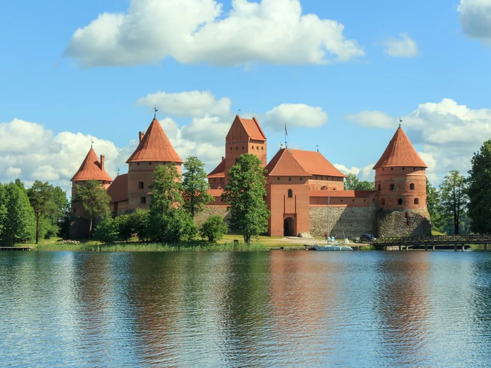 Trakai Island Castle reflected in the still waters of Lake Galvė at sunset, Lithuania
