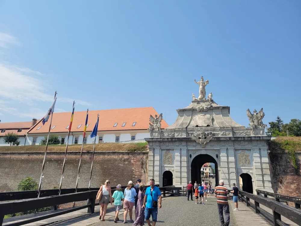 Alba Iulia Citadel (Cetatea Alba Iulia) in Transylvania, Romania — Gate III (the Kaisertor) of the Habsburg Baroque star fort built 1716–1735, with relief sculptures depicting Habsburg military victories and the Cathedral of Saint Michael beyond