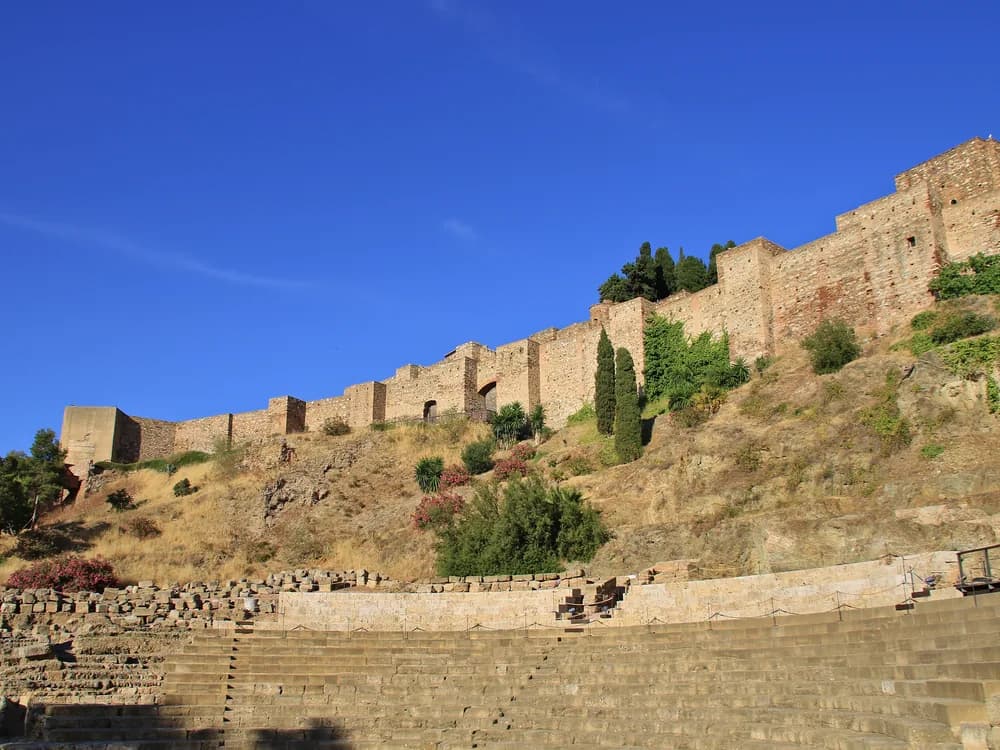 Alcazaba de Málaga — the 11th-century Moorish palace-fortress on the slopes of Monte Gibralfaro, with garden courtyards and defensive towers above the city centre