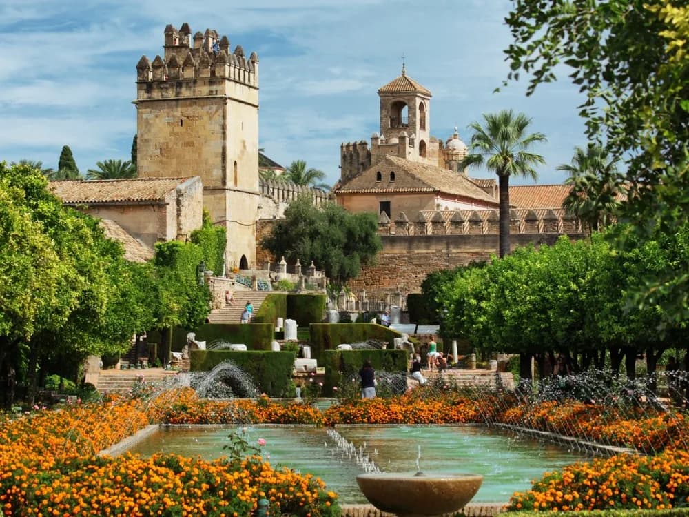 The Alcázar de los Reyes Cristianos in Córdoba, Andalusia — towers and terraced Moorish gardens of the Catholic Monarchs' fortress-palace beside the Guadalquivir