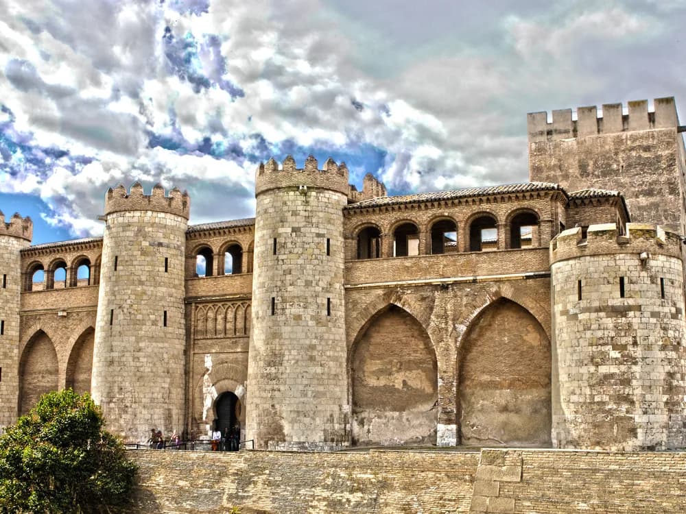 Aljafería Palace in Zaragoza — the 1065 Taifa palace of Al-Muqtadir, the northernmost Muslim palace in Europe, with its interlaced arch throne room and the Catholic Monarchs' coffered ceiling