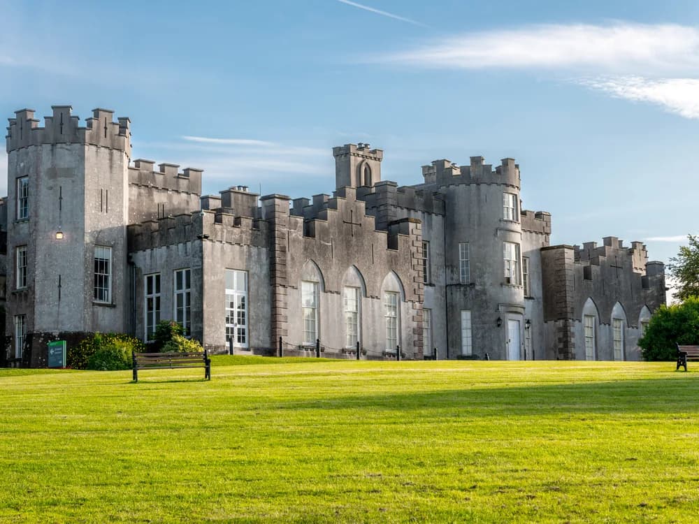 Ardgillan Castle on the coastal cliffs above the Irish Sea in north County Dublin, the battlemented Victorian house above its walled gardens and demesne parkland