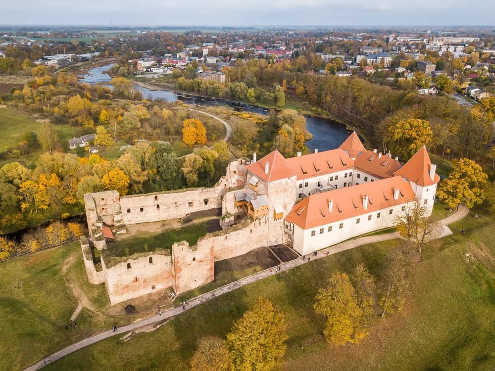 Bauska Castle (Bauskas pils) at the confluence of the Mūsa and Mēmele rivers in Zemgale, Latvia — the ruins of the Livonian Order fortress and the restored Kettler ducal palace on their natural river peninsula