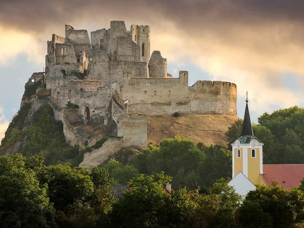 Beckov Castle (Hrad Beckov) on its 60-metre limestone cliff above the Váh River in the Trenčín Region of Slovakia — the Gothic ruin of Stibor of Stiboricz's personal seat