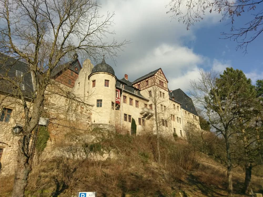 Beichlingen Palace on its hilltop in rural Thuringia — a large medieval palace complex now offering an escape-room-style exploration through normally inaccessible spaces