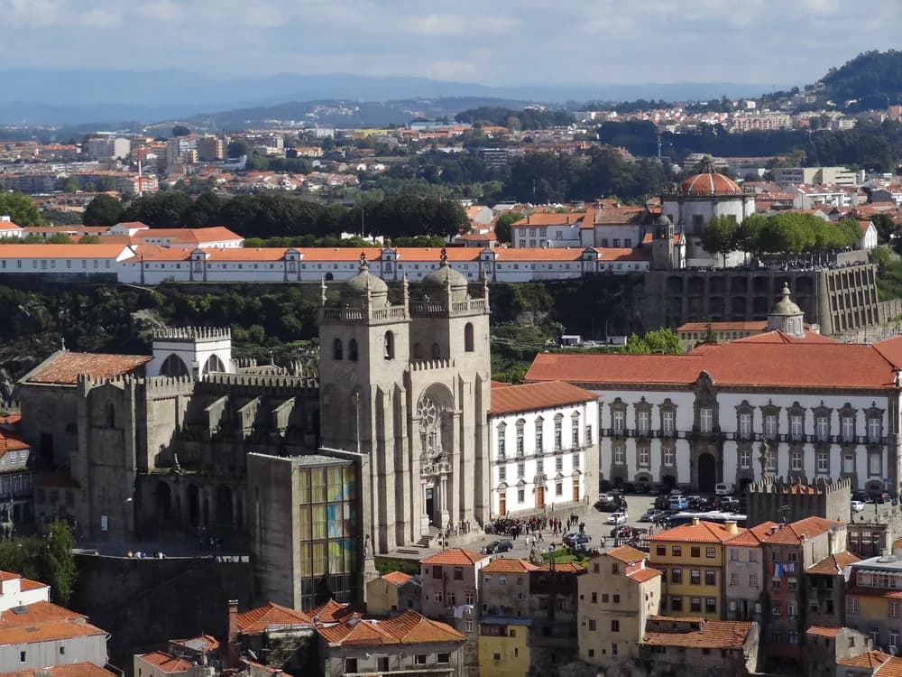 The Bishop's Palace of Porto beside the Sé Cathedral, rising above the historic Ribeira district with the Douro River visible below