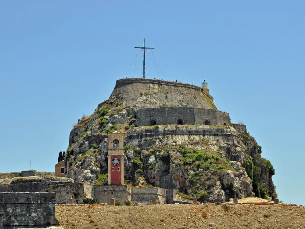 Old Fortress of Corfu (Palaio Frourio) on its double-peaked rocky promontory, with the Venetian inner harbour and sea channel visible from Corfu Town