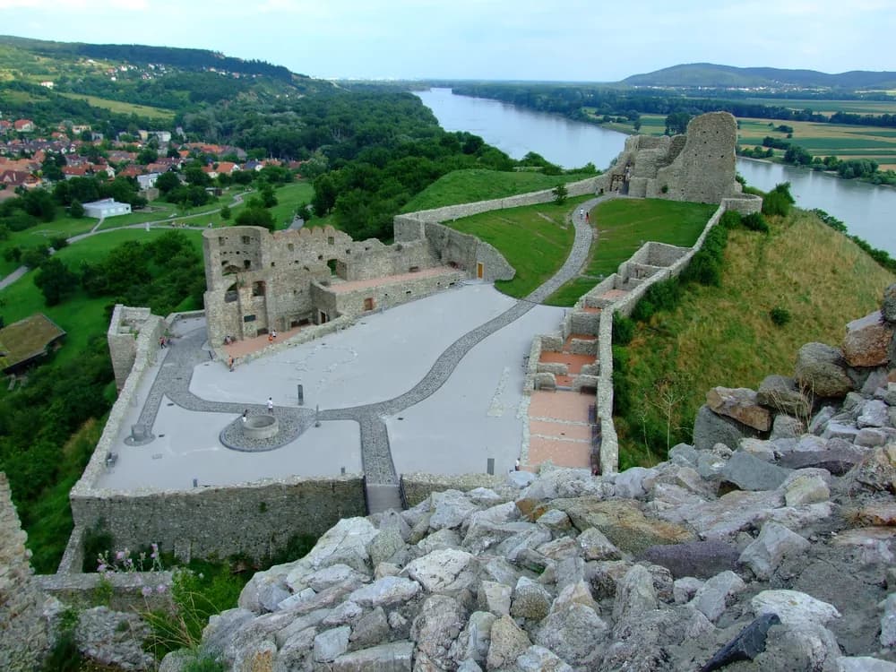 Devín Castle ruins on their rock at the Danube-Morava confluence near Bratislava — the Great Moravian frontier fortress destroyed by Napoleon in 1809, a symbol of Slovak national identity and Cold War Iron Curtain border