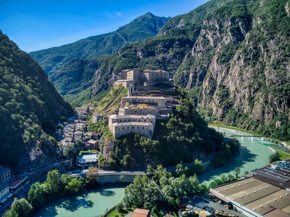 The Fortress of Bard rising in tiers on its rock spur above the Dora Baltea gorge in the Valle d'Aosta, with the Alps beyond