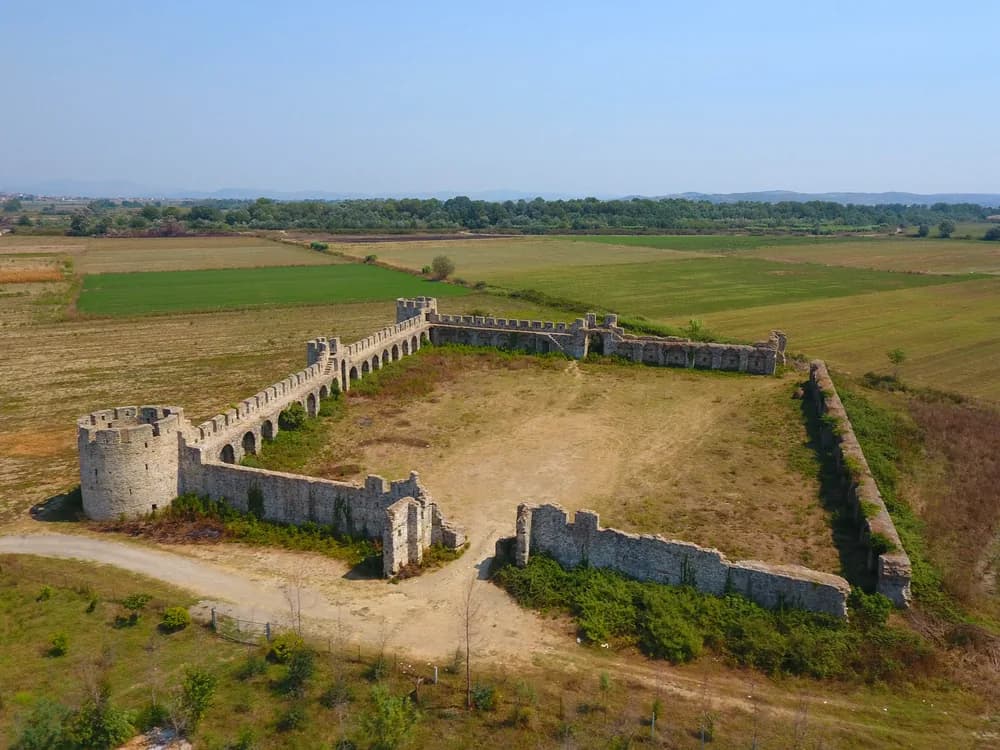 The Fortress of Bashtova rising from the Albanian coastal plain at the mouth of the Shkumbin River — a 15th-century Venetian-Ottoman quadrangular fortress