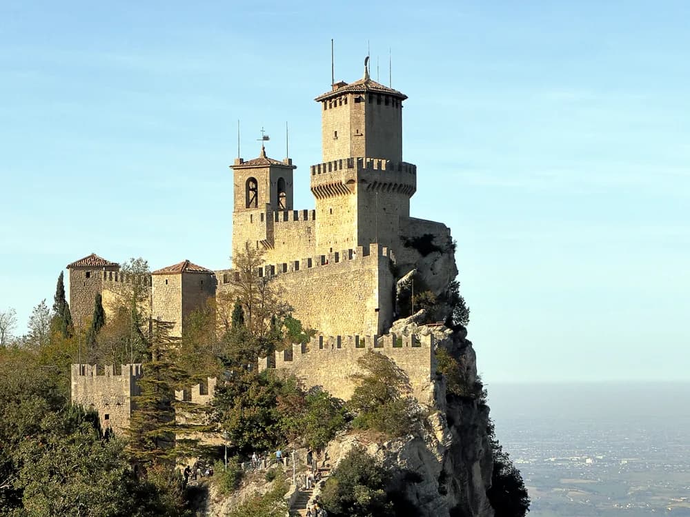 Guaita Tower (Prima Torre) on the limestone cliffs of Mount Titano in the Republic of San Marino, with the Adriatic Plain visible beyond