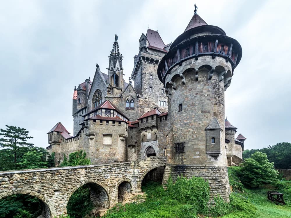 Kreuzenstein Castle (Burg Kreuzenstein) on its limestone ridge above Leobendorf, Lower Austria — the 19th-century romantic reconstruction built with genuine medieval fragments by Count Wilczek, 25 km north of Vienna