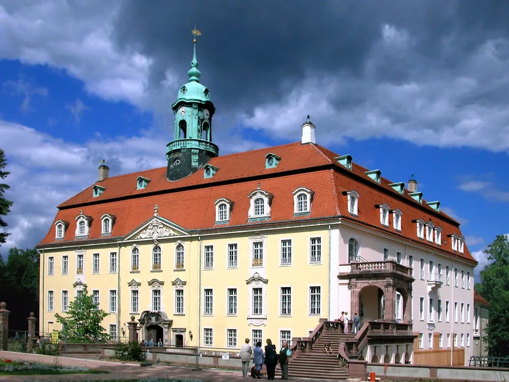 Lichtenwalde Castle in Saxony viewed from the Baroque cascade park below, the three-wing palace above terraced fountain gardens in the Zschopau valley foothills