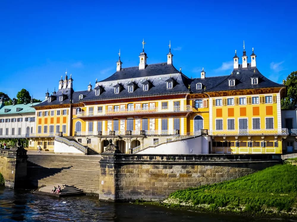 Pillnitz Palace on the Elbe river east of Dresden — the chinoiserie Baroque Wasserpalais of Augustus the Strong, designed by Pöppelmann, with the Elbe embankment and formal garden