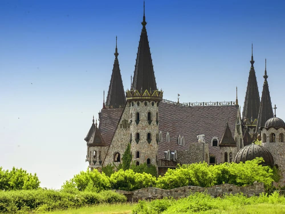 Ravadinovo Castle ('In Love with Wind') on Bulgaria's Black Sea coast — the neo-medieval towers and formal gardens of Georgi Tumpalov's hand-built limestone castle still under construction
