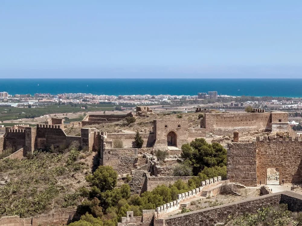 Sagunto Castle on the limestone ridge above Sagunto — the 7-hectare multi-period fortress where Hannibal's 219 BC siege of Saguntum triggered the Second Punic War, 25km from Valencia