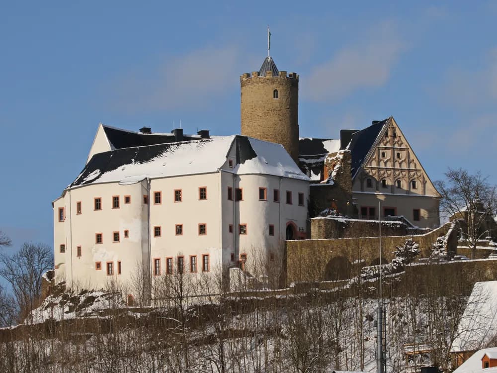 Scharfenstein Castle in the Ore Mountains of Saxony, the medieval hill fortress on its rocky spur above the Zschopau valley, circular keep and curtain walls amid forest