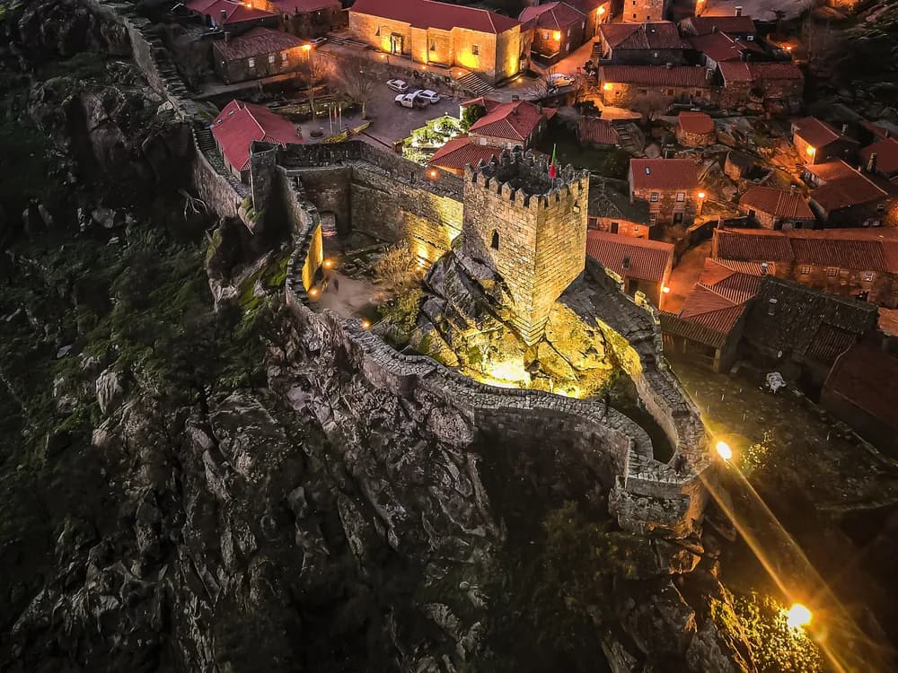 Sortelha Castle and historic village in the Serra da Malcata — granite walls emerging from the natural bedrock, the pedra viva principle, in one of Portugal's twelve aldeias históricas