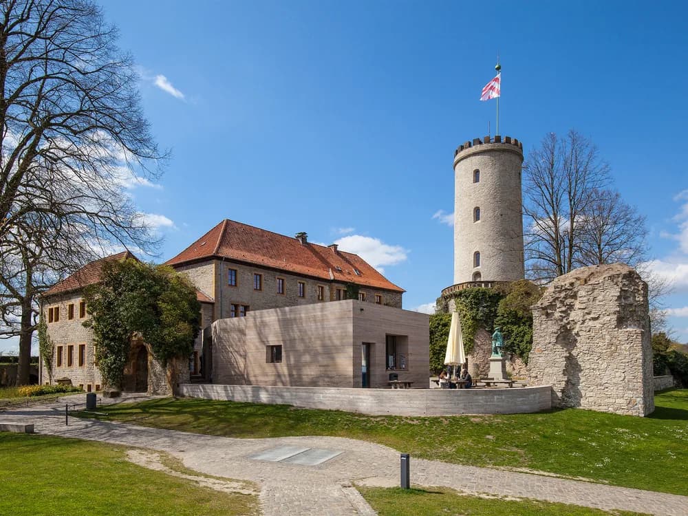Sparrenburg Castle tower above Bielefeld, Westphalia — the medieval hilltop fortress whose 300-metre underground casemates are the city's most atmospheric heritage experience