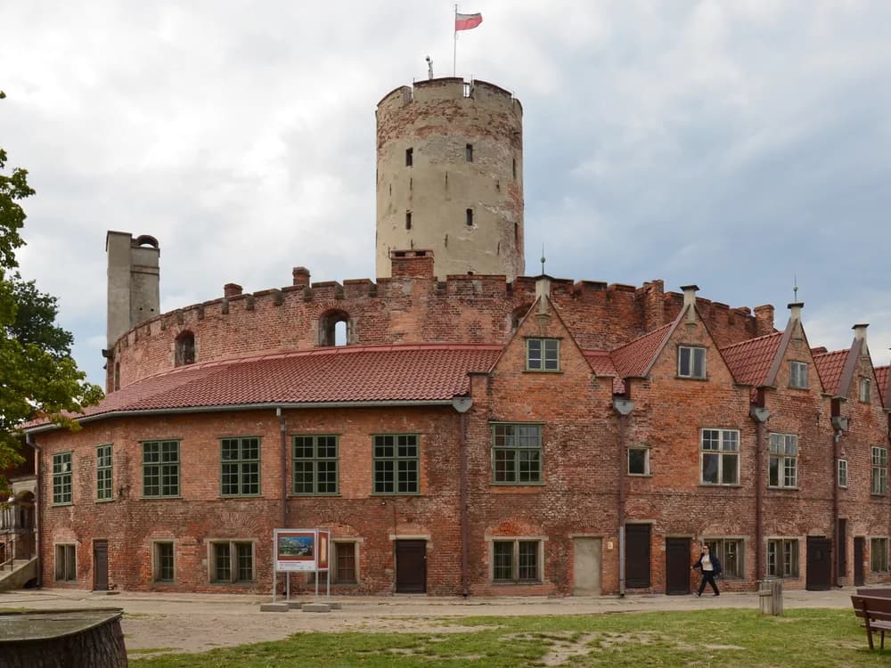 Wisłoujście Fortress at the mouth of the Vistula River near Gdańsk — the 1482 round tower and Renaissance artillery bastions of Poland's harbour guardian, reached by boat from Gdańsk