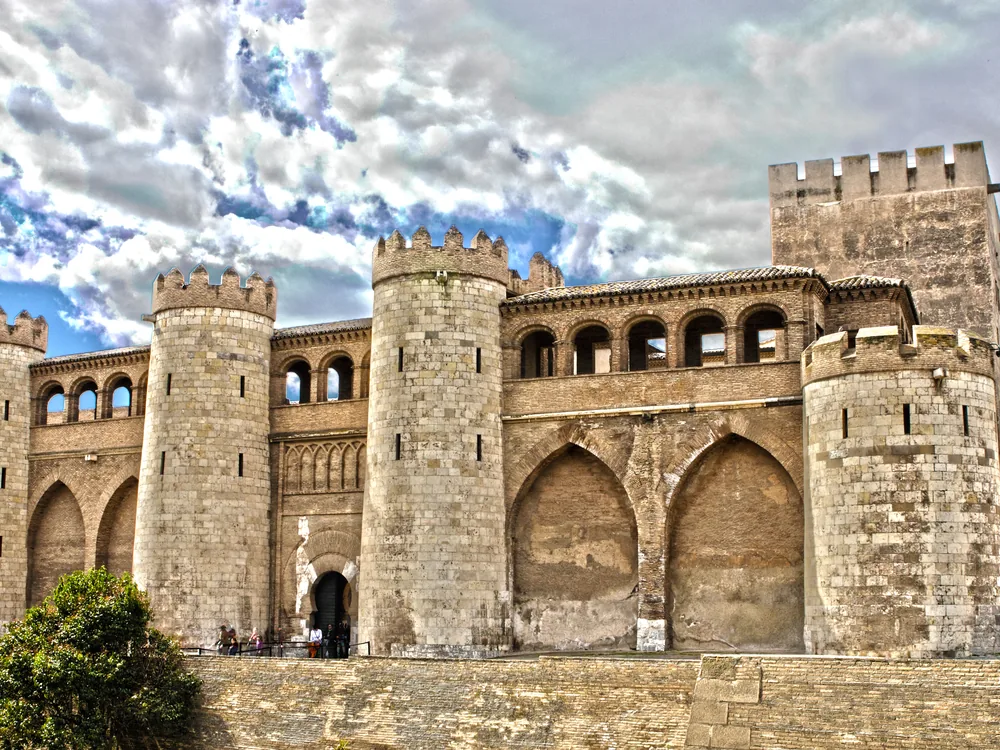 Aljafería Palace in Zaragoza — the 1065 Taifa palace of Al-Muqtadir, the northernmost Muslim palace in Europe, with its interlaced arch throne room and the Catholic Monarchs' coffered ceiling