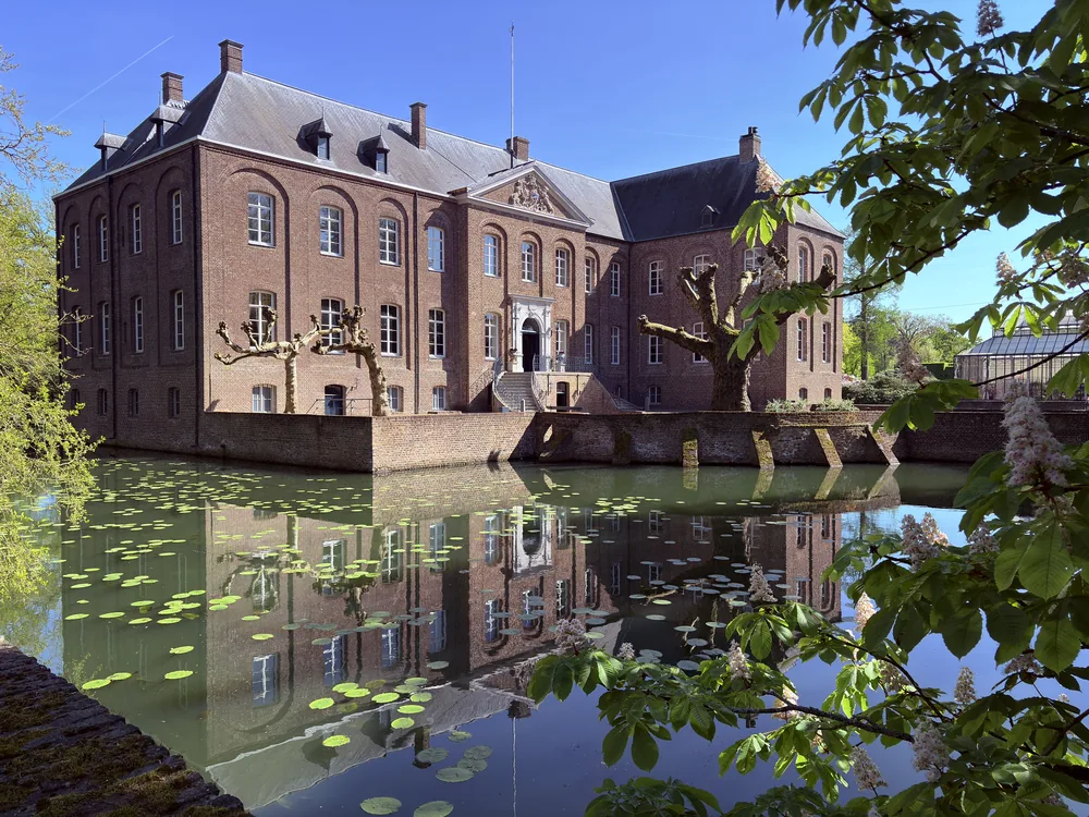 Arcen Castle in Limburg, Netherlands — the 1709 baroque manor shell whose interior was destroyed in 1944, now the centrepiece of the Kasteeltuinen Arcen, one of the Netherlands' most elaborate garden estates
