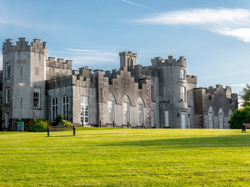 Ardgillan Castle on the coastal cliffs above the Irish Sea in north County Dublin, the battlemented Victorian house above its walled gardens and demesne parkland