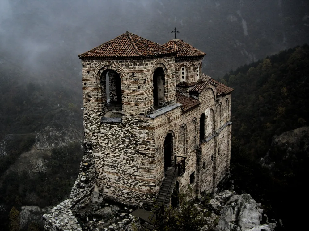 Asen's Fortress and the Church of the Holy Mother of God on the cliff above the Asenitsa River gorge in the Rhodope Mountains near Asenovgrad, Bulgaria