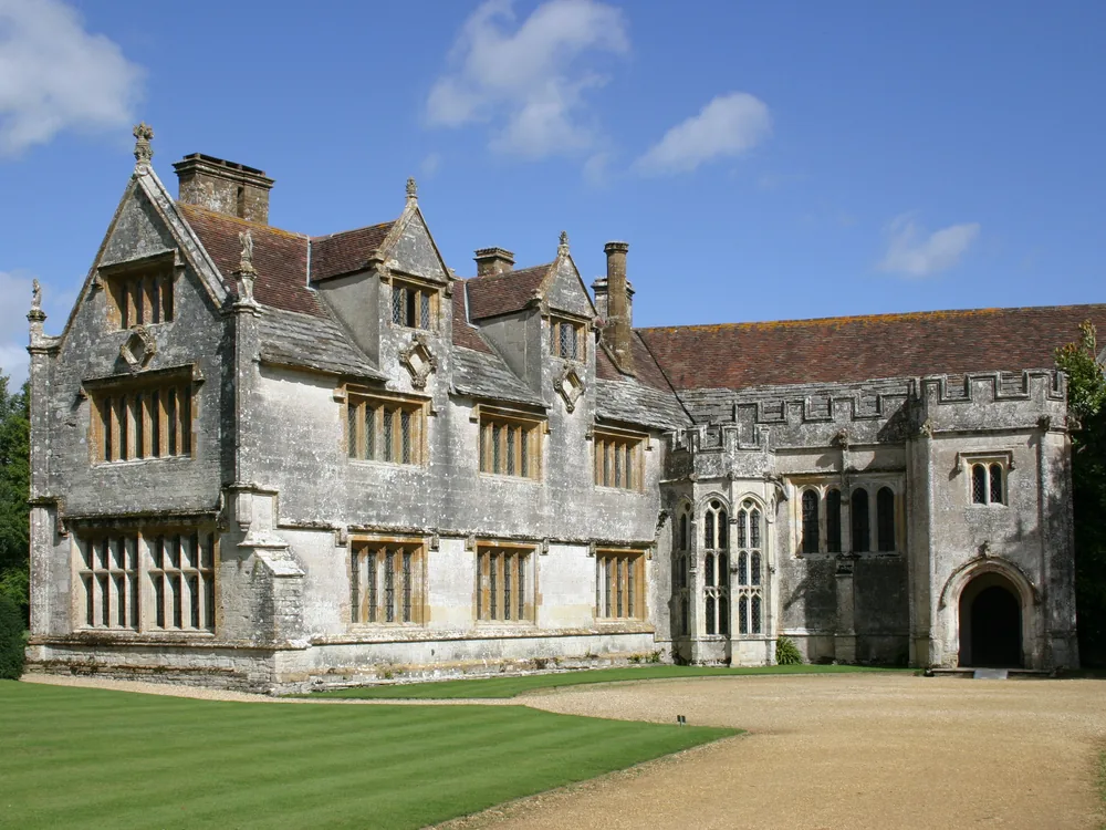 Athelhampton House in Dorset, England — the 1485 Great Hall and its Grade I listed formal gardens with clipped yew pyramids